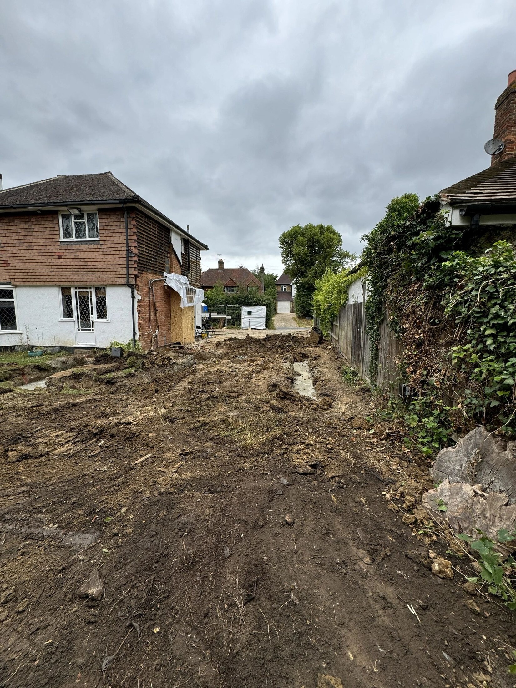 Cleared area at the Cobham property following garage demolition and concrete slab removal.