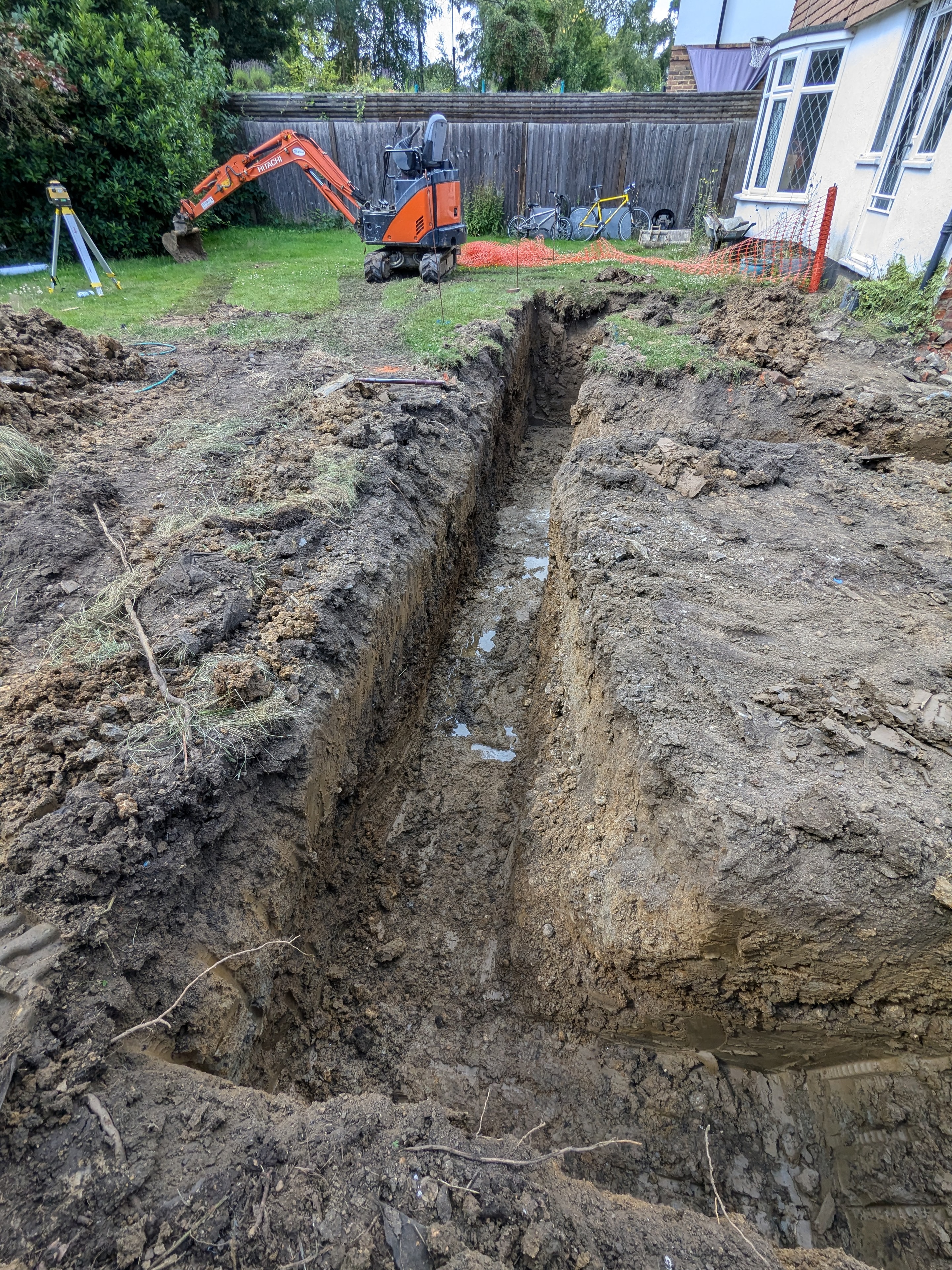Excavator carrying out groundworks at the Cobham property.