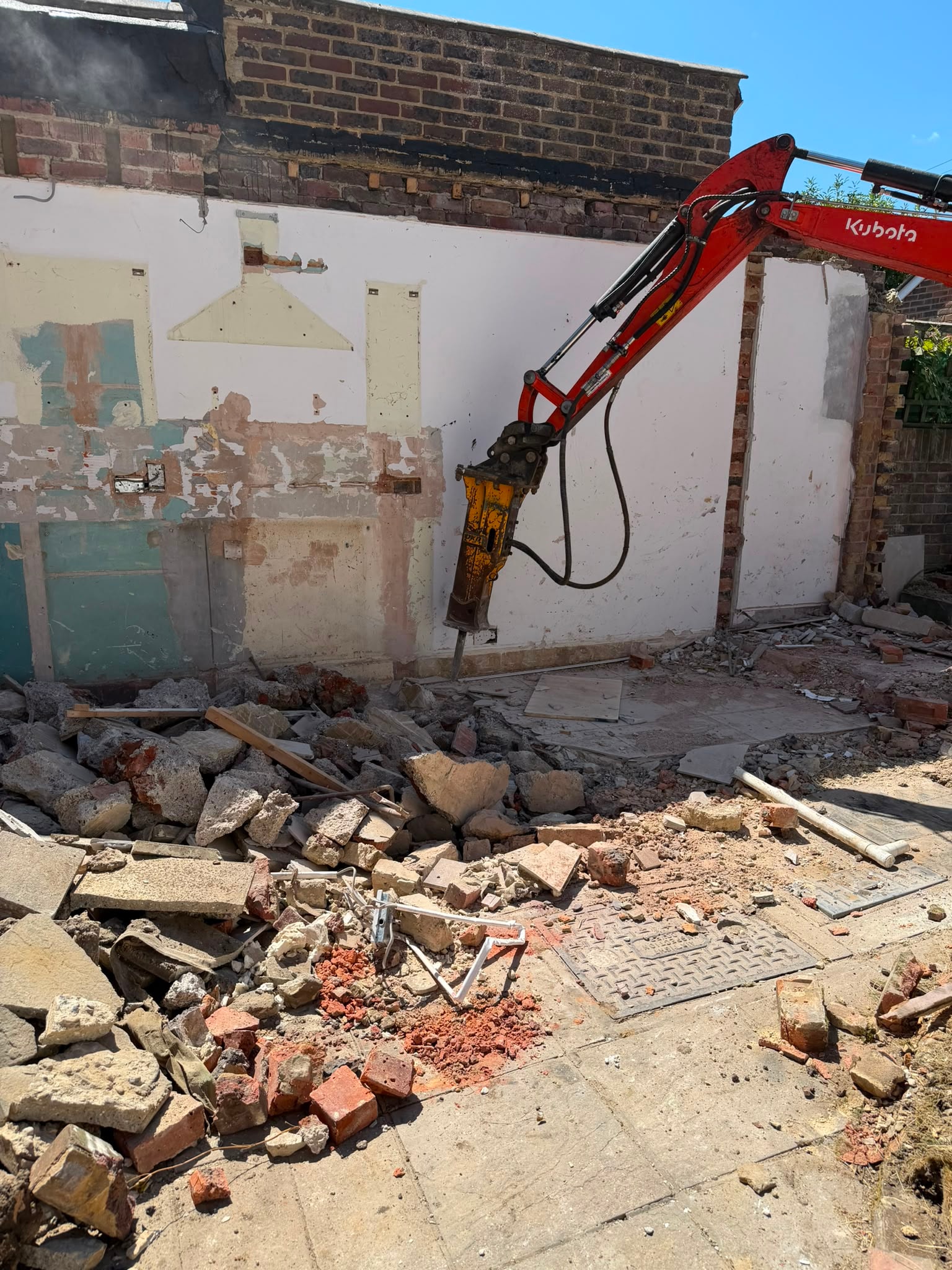 Excavator carrying out extension demolition at Pulborough.