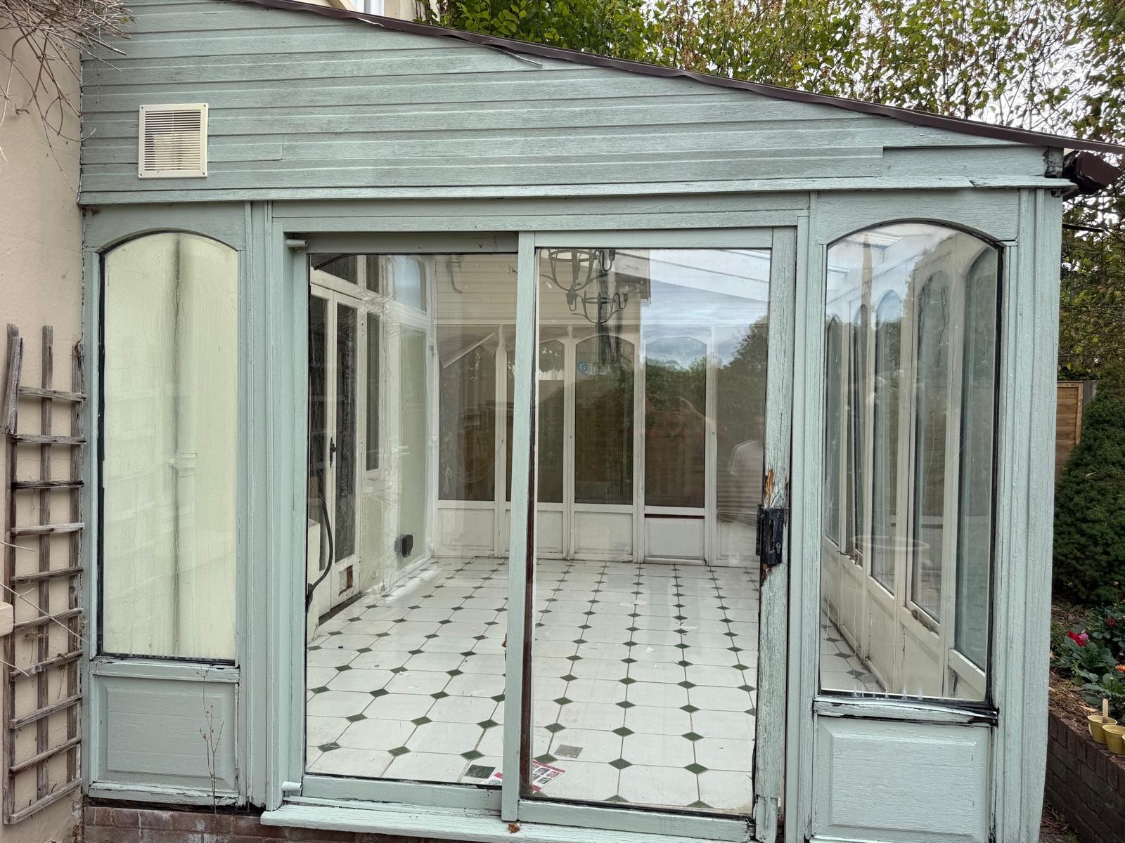Ageing timber conservatory before demolition in Reigate, Surrey