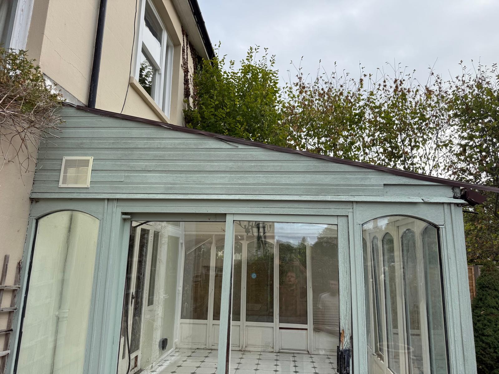 Conservatory roofline and glazing before demolition in Reigate