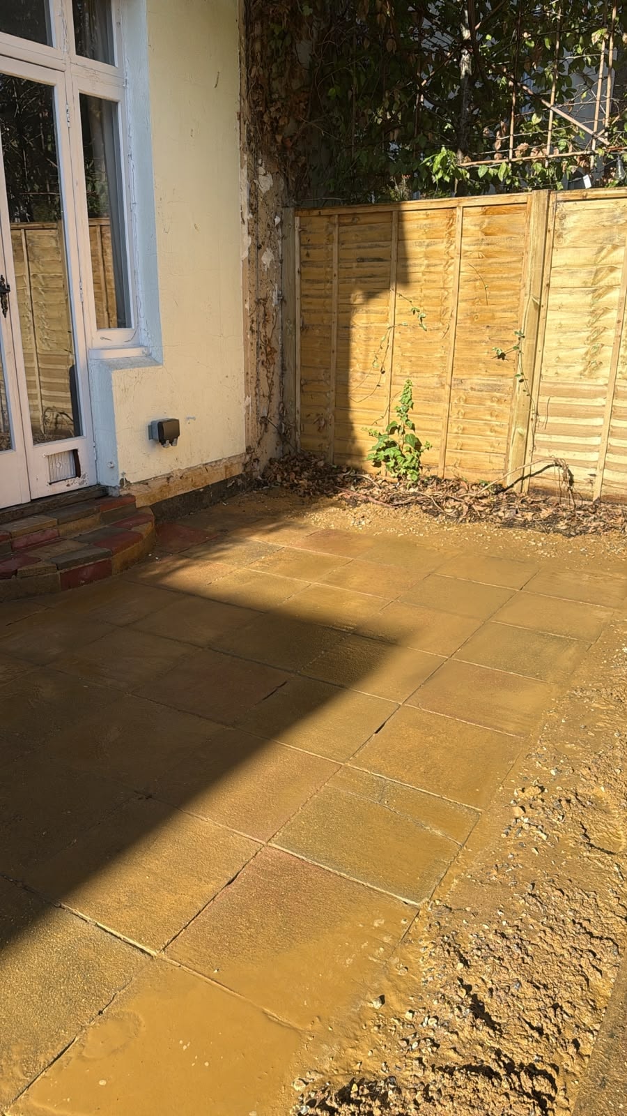 Corner view of cleared conservatory footprint in Reigate