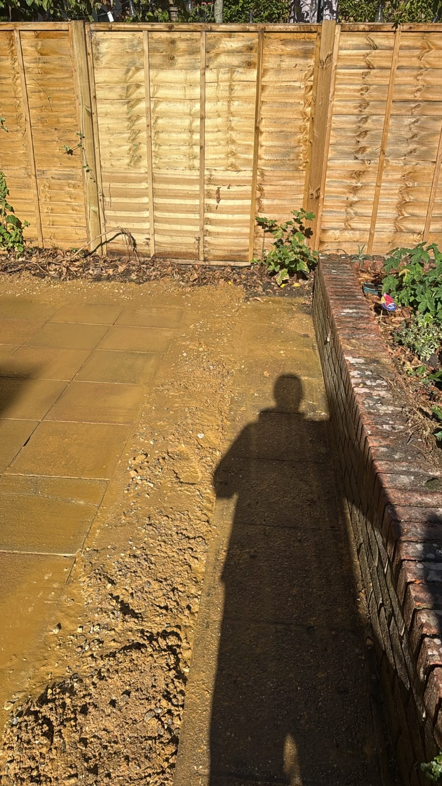Paving edge and retaining wall retained following conservatory demolition in Reigate