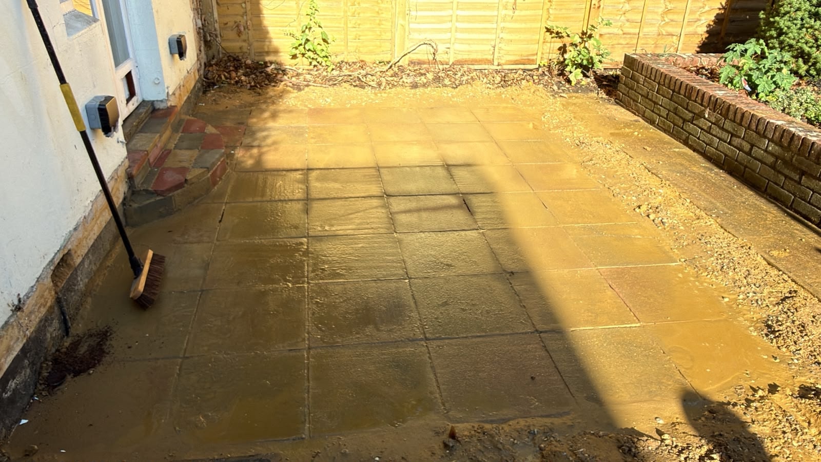 Cleared conservatory footprint following demolition and slab removal in Reigate.