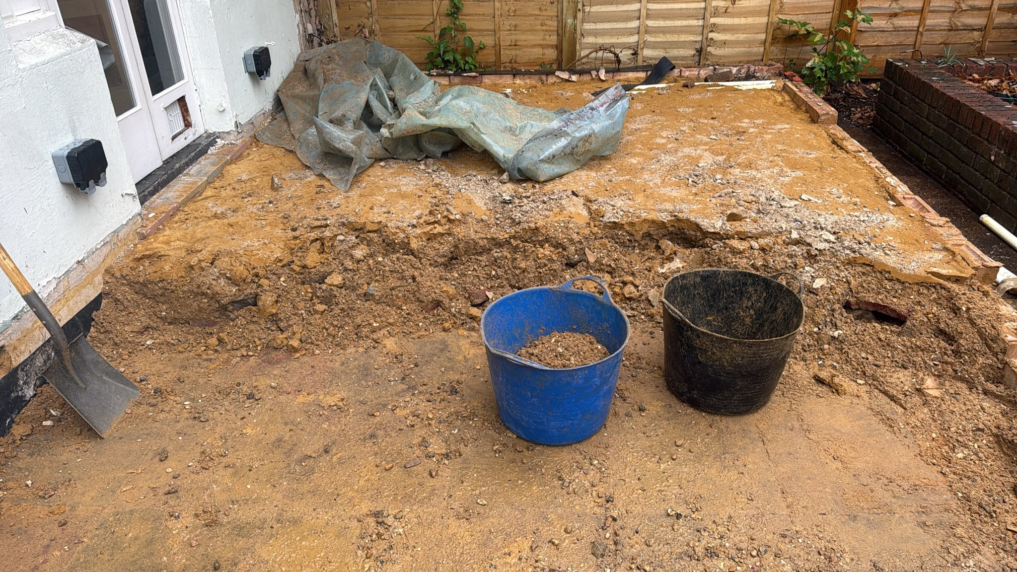Ground exposed and reduced following slab removal in Reigate